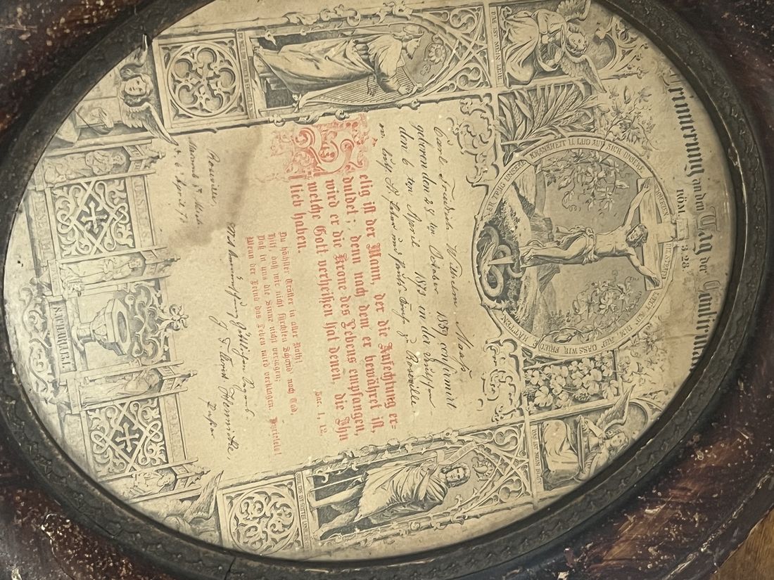 An oval-framed German Lutheran confirmation certificate, lithographed with hand-written details in ink