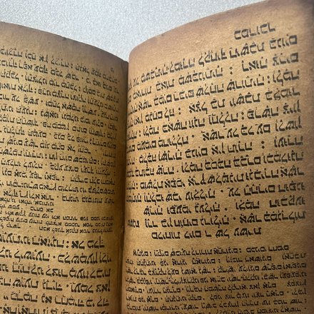 Dense hand-written right-to-left script in rounded letterforms on heavily browned paper